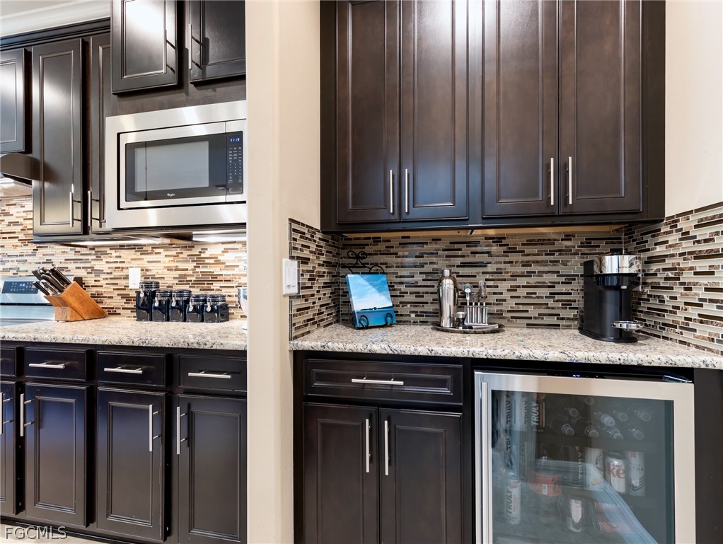 10878 Dennington Road Fort Myers, FL 33913 - Photo 23 of 50 a kitchen with granite countertop cabinets stainless steel appliances and a sink