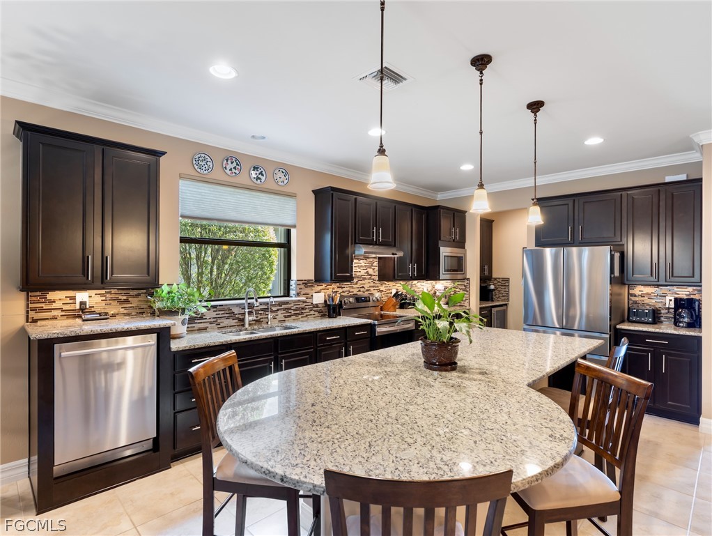 10878 Dennington Road Fort Myers, FL 33913 - Photo 28 of 50 a kitchen with a table and chairs