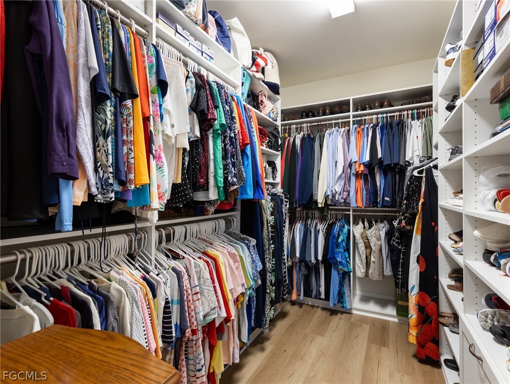 10878 Dennington Road Fort Myers, FL 33913 - Photo 32 of 50 a view of walk in closet with clothes and shoes