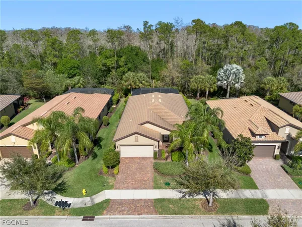 an aerial view of a house with a yard