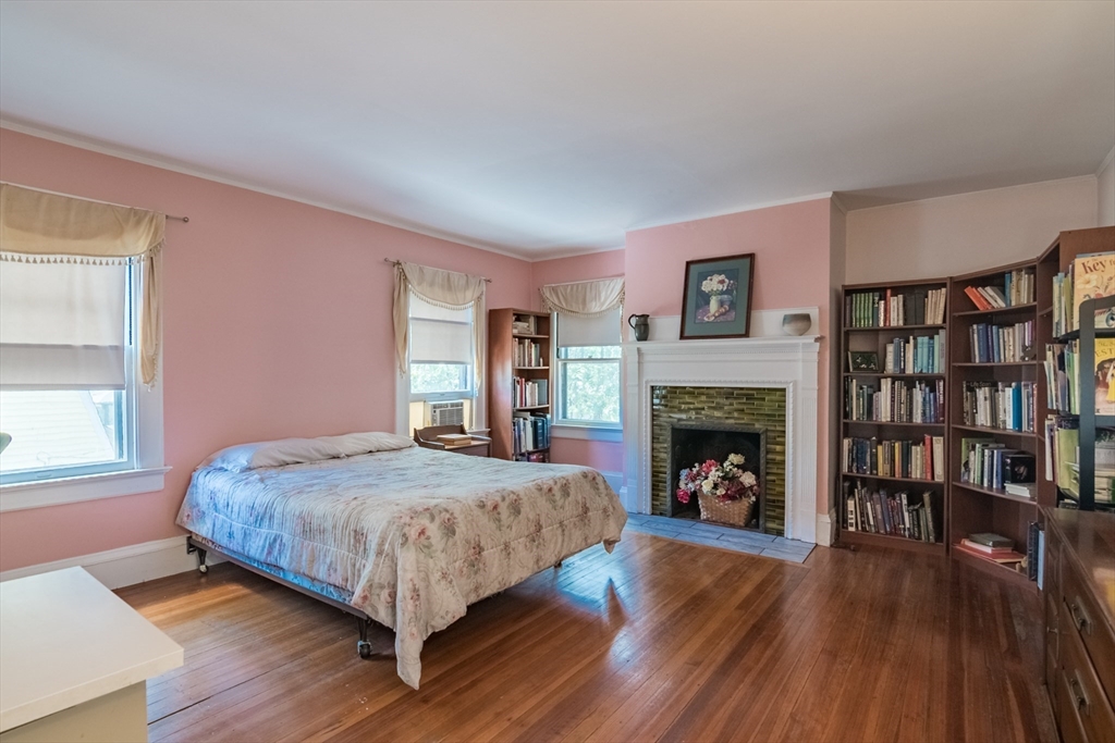 128 Maplewood Terrace Springfield, MA 01108 - Photo 25 of 42 a bed sitting in a spacious bedroom next to a fireplace