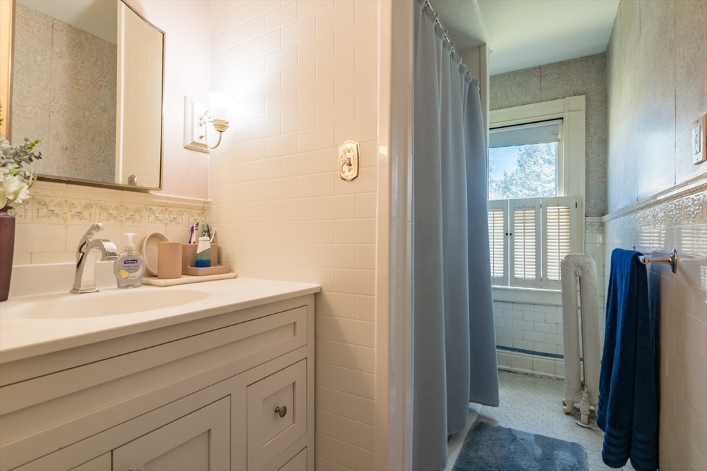 128 Maplewood Terrace Springfield, MA 01108 - Photo 27 of 42 a bathroom with a sink vanity and a mirror