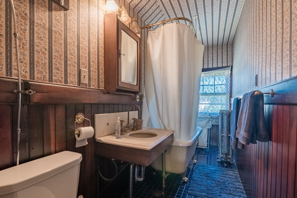 128 Maplewood Terrace Springfield, MA 01108 - Photo 29 of 42 a bathroom with a sink a toilet and a large mirror