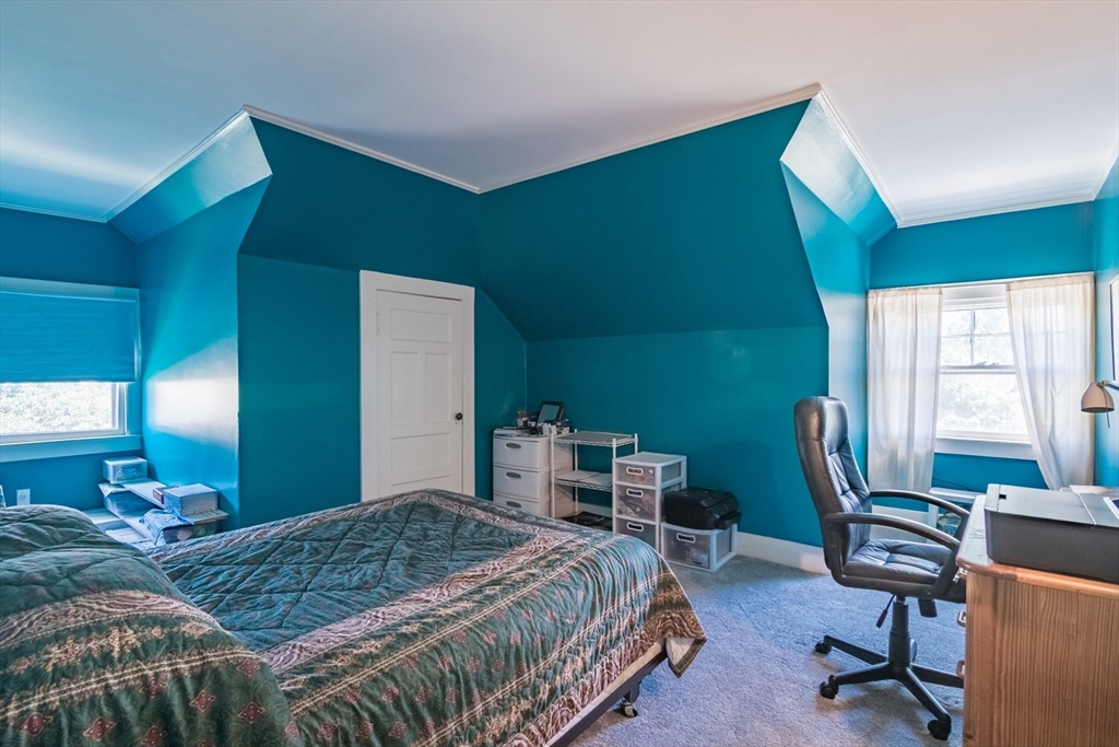128 Maplewood Terrace Springfield, MA 01108 - Photo 30 of 42 a bedroom with a bed a desk and chair with the large windows