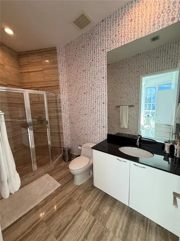 a large bed sitting in a bedroom next to a window