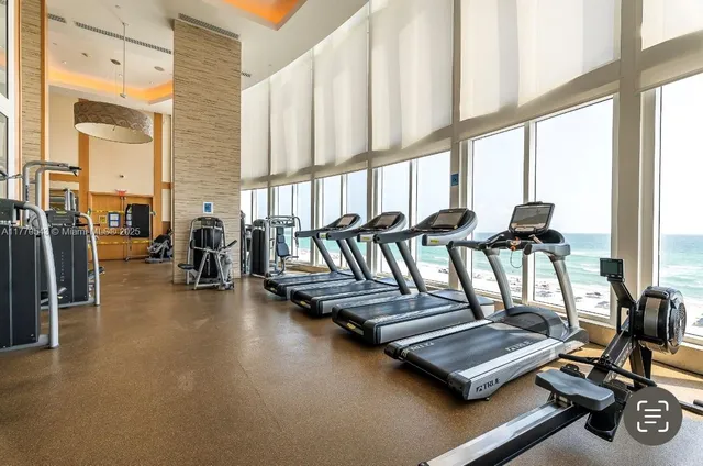 a view of livingroom with dining room and furniture floor to ceiling windows