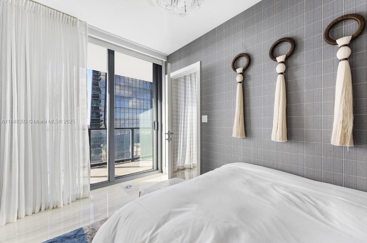1451 Brickell Avenue, Unit 2505 Miami, FL 33131 - Photo 12 of 30 a bedroom with a bed and a window