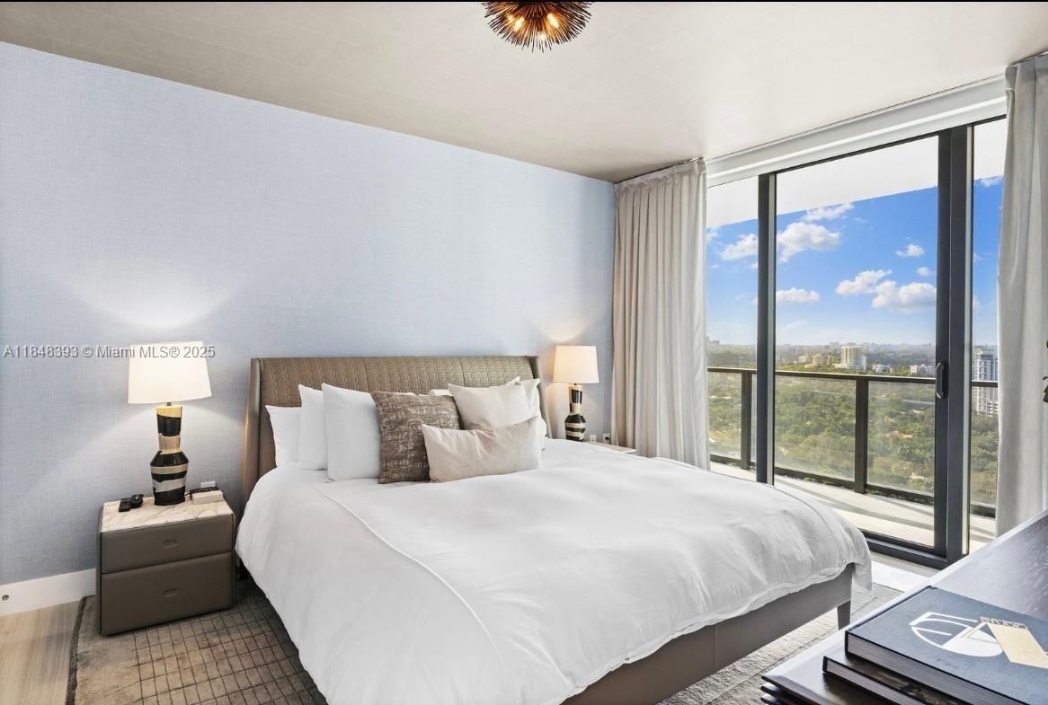 1451 Brickell Avenue, Unit 2505 Miami, FL 33131 - Photo 14 of 30 a bedroom with a large bed and a large window