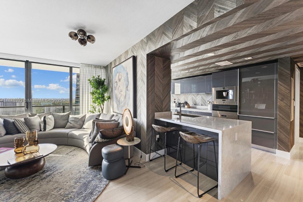 1451 Brickell Avenue, Unit 2505 Miami, FL 33131 - Photo 19 of 30 a living room with furniture and a large window