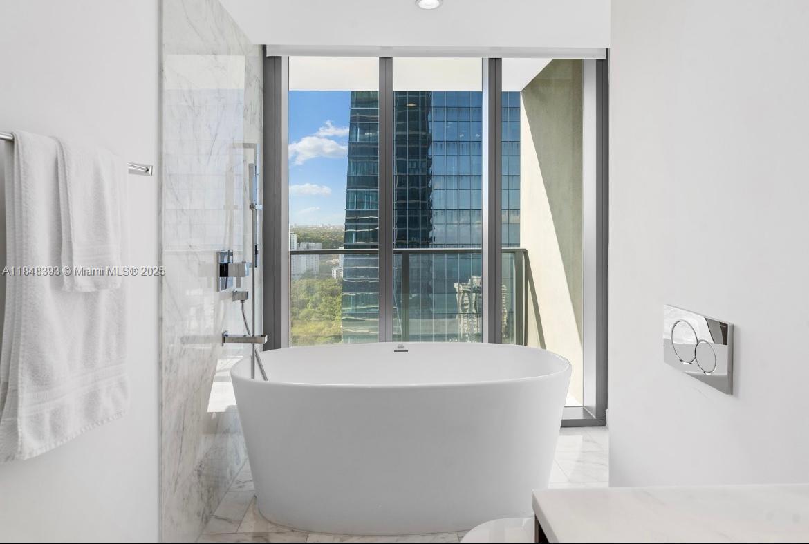 1451 Brickell Avenue, Unit 2505 Miami, FL 33131 - Photo 8 of 30 a bathroom with a bathtub and shower