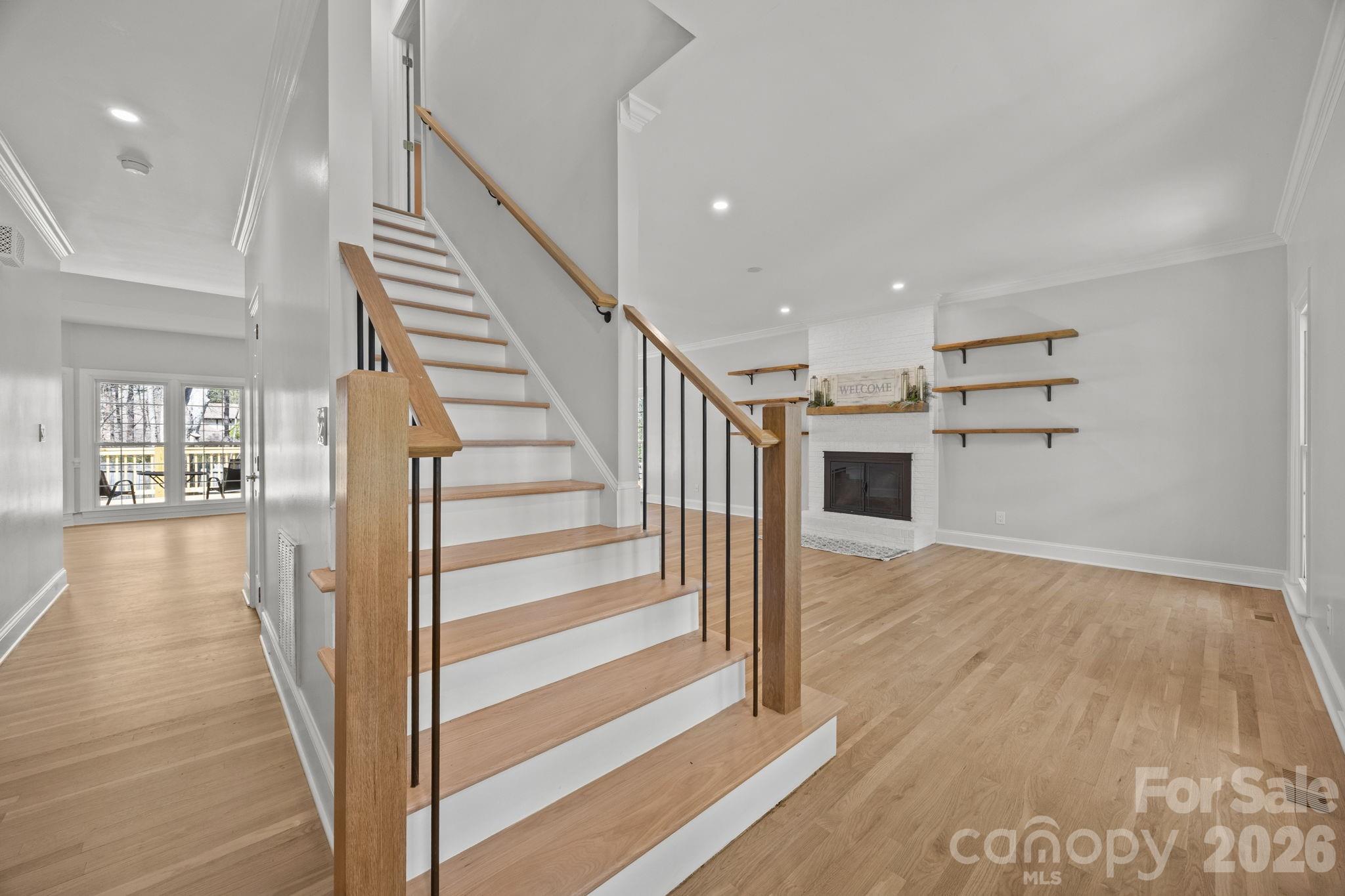 5243 Mintridge Road Mint Hill, NC 28227 - Photo 7 of 43 a view of a hallway with wooden floor and staircase