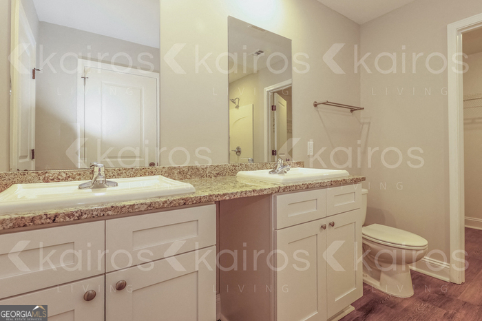 155 Cottage Grove Road Brunswick, GA 31525 - Photo 10 of 16 a bathroom with a granite countertop sink a toilet and a shower