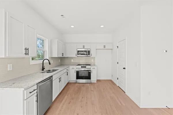 a large kitchen with a stove top oven