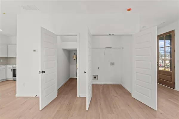 a view of a room with wooden floor