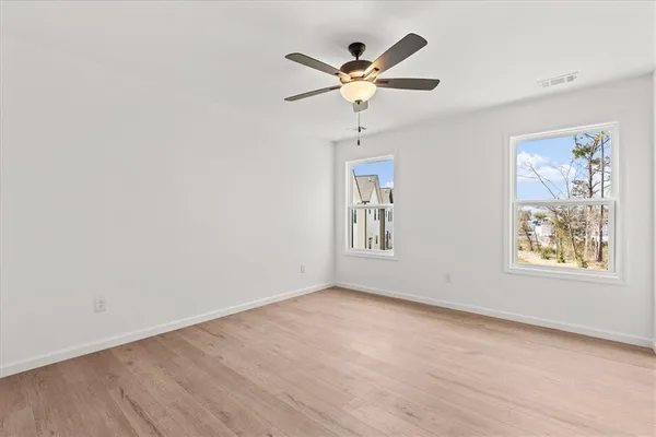 wooden floor in an empty room with a window