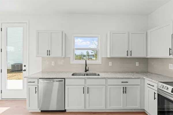 a kitchen with white cabinets and white appliances