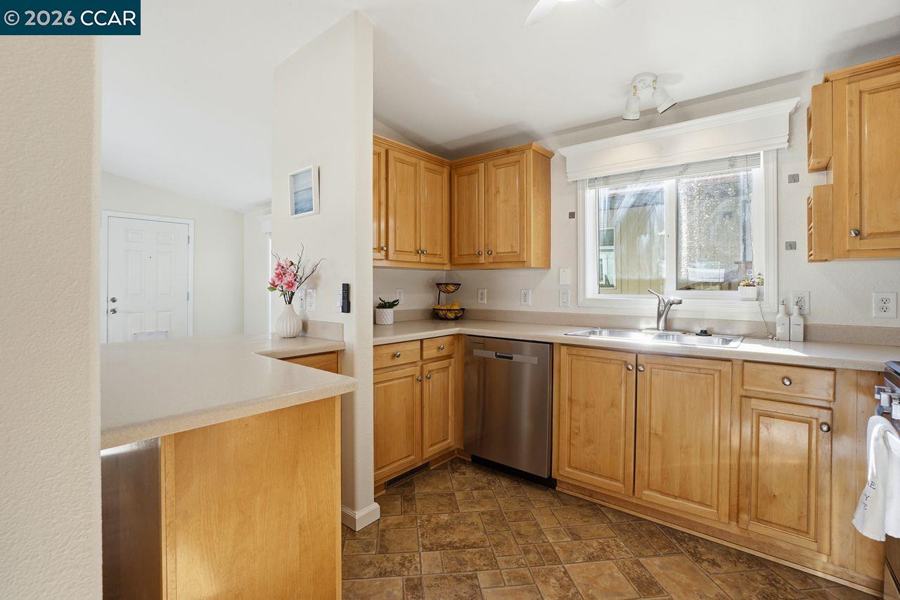 3777 Willow Pass Road, Unit 20 Bay Point, CA 94565 - Photo 13 of 35 a kitchen that has a sink and a stove in it