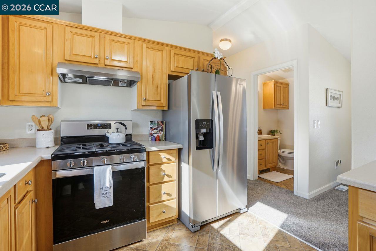 3777 Willow Pass Road, Unit 20 Bay Point, CA 94565 - Photo 14 of 35 a kitchen with stainless steel appliances granite countertop a refrigerator stove and sink