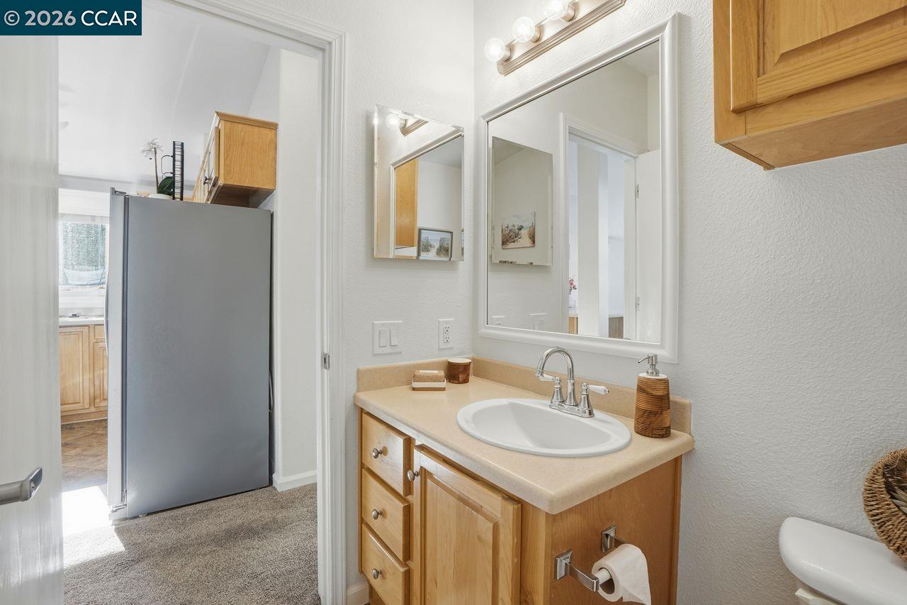 3777 Willow Pass Road, Unit 20 Bay Point, CA 94565 - Photo 25 of 35 a bathroom with a sink and a mirror