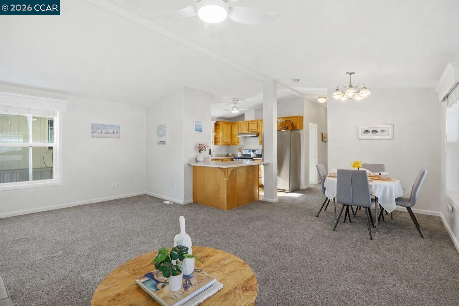 3777 Willow Pass Road, Unit 20 Bay Point, CA 94565 - Photo 6 of 35 a living room with furniture a chandelier and a dining table