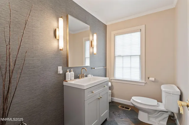 a spacious bedroom with a bed and glass walk in closet