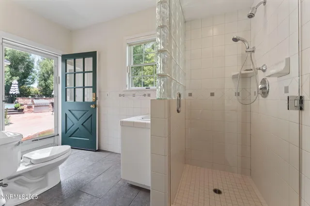 a living room with furniture a flat screen tv and a large window