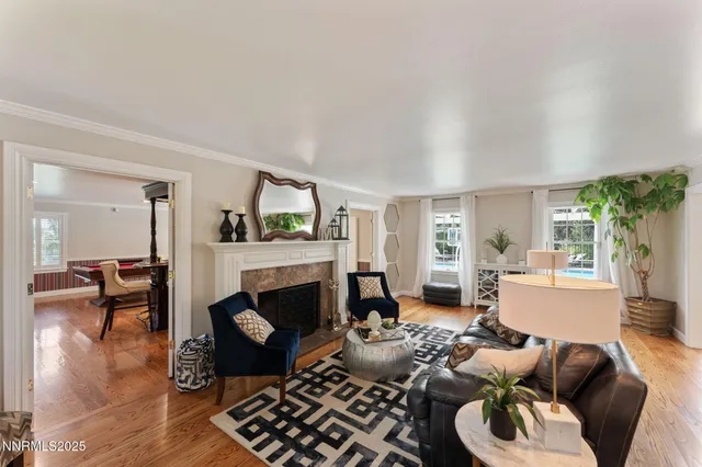 a dining room with furniture a chandelier and wooden floor