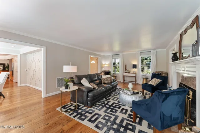 a dining room with furniture wooden floor and a chandelier