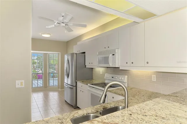 a kitchen with a stove cabinets and a refrigerator
