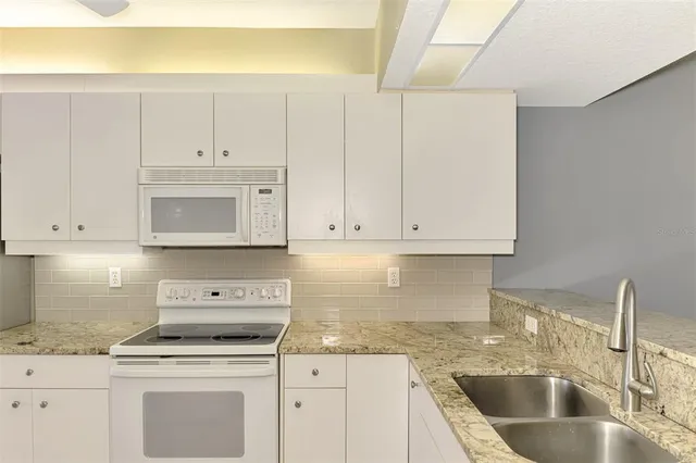 a view of an entryway with wooden floor and door