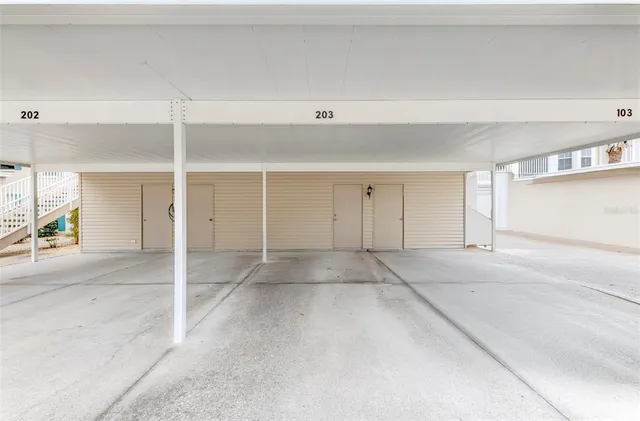 an aerial view of residential houses with outdoor space and lake view
