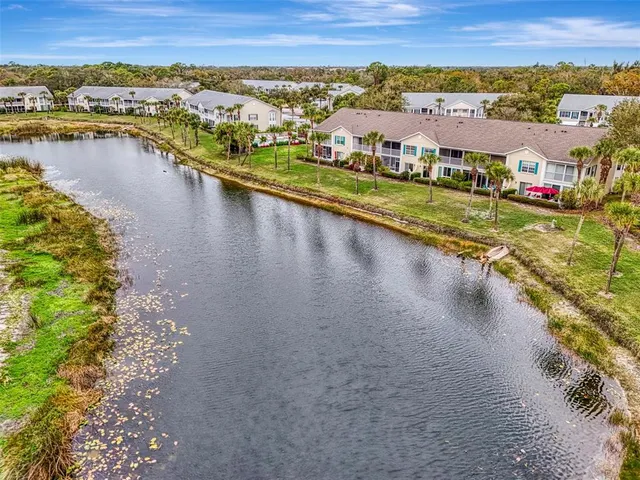 an aerial view of multiple houses with yard