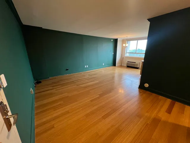 a kitchen with stainless steel appliances granite countertop a refrigerator a stove a sink and a microwave oven with wooden floor