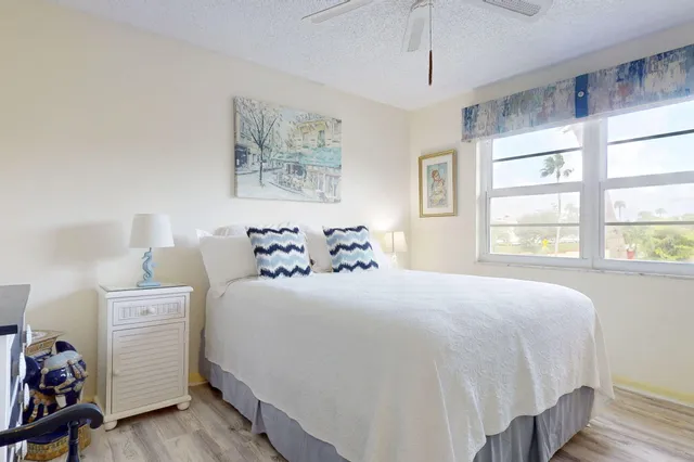 a bedroom with a bed and a flat tv screen on wall