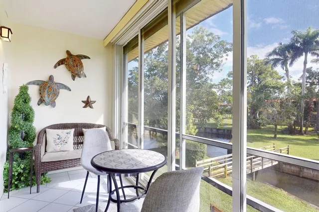 a view of a room with a large window and table