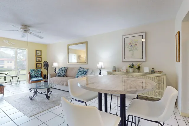 a view of a dining room with furniture and a window