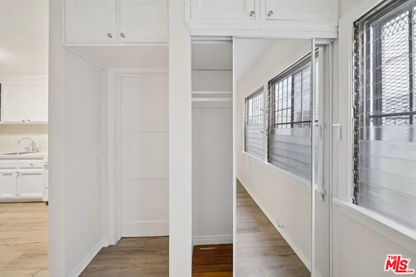 a view of a hallway with wooden floor and staircase