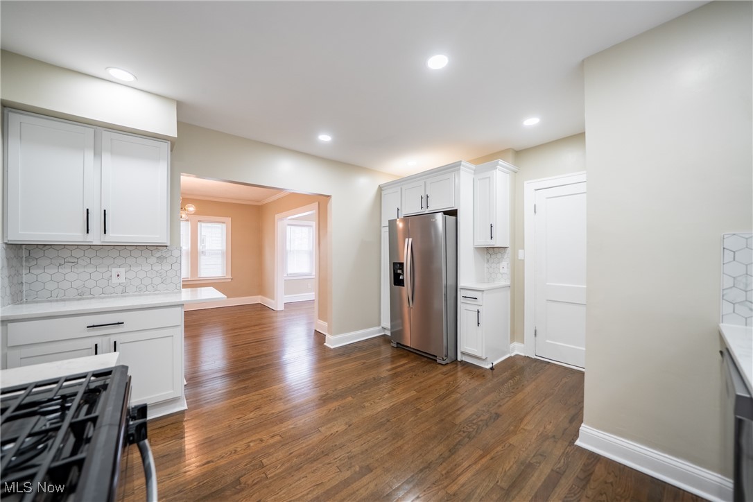 3816 Summit Park Road Cleveland Heights, OH 44121 - Photo 13 of 35 Kitchen featuring backsplash, white cabinets, range with gas cooktop, stainless steel fridge, and recessed lighting