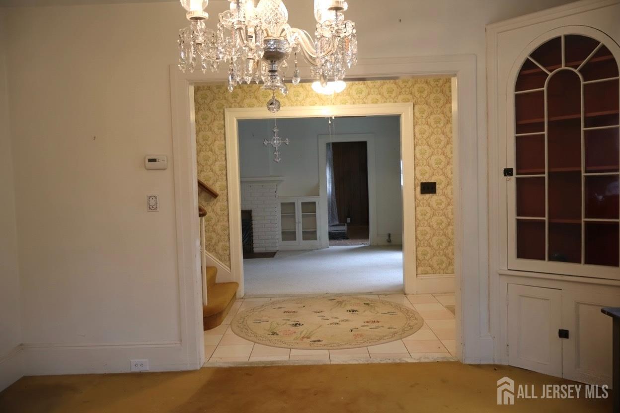 40 Prospect Street Summit, NJ 07901 - Photo 5 of 17 a view of a hallway with wooden floor and a chandelier