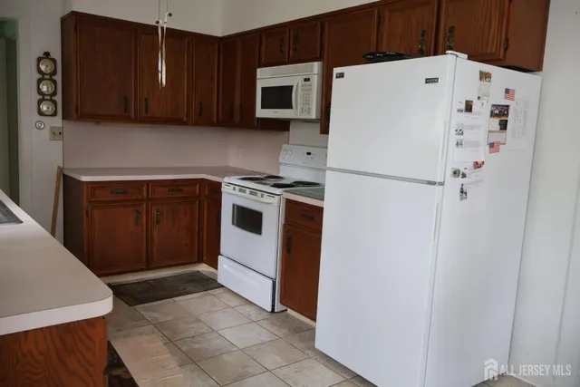 a white refrigerator freezer sitting inside of a kitchen