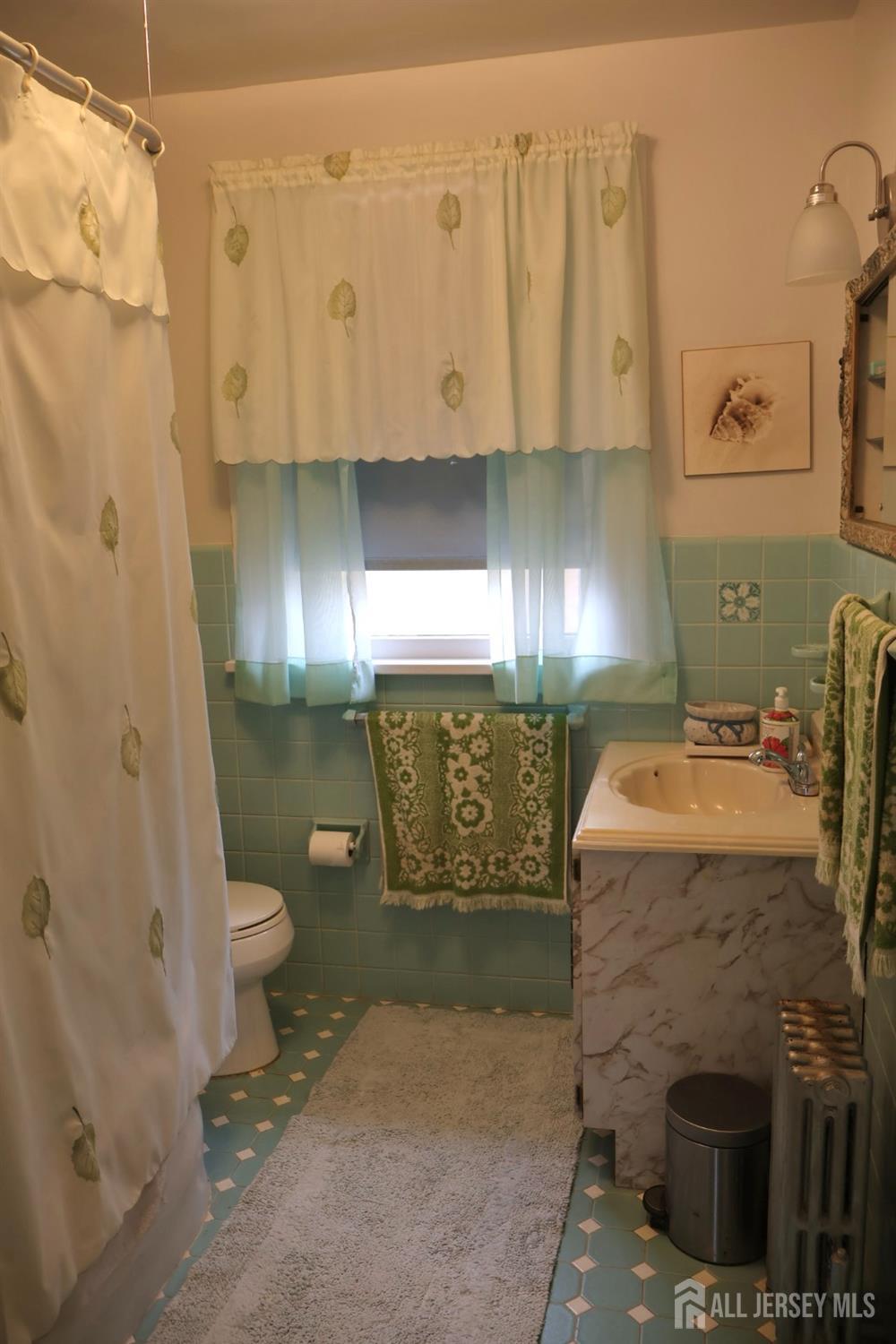 40 Prospect Street Summit, NJ 07901 - Photo 9 of 17 a bathroom with a sink toilet and shower