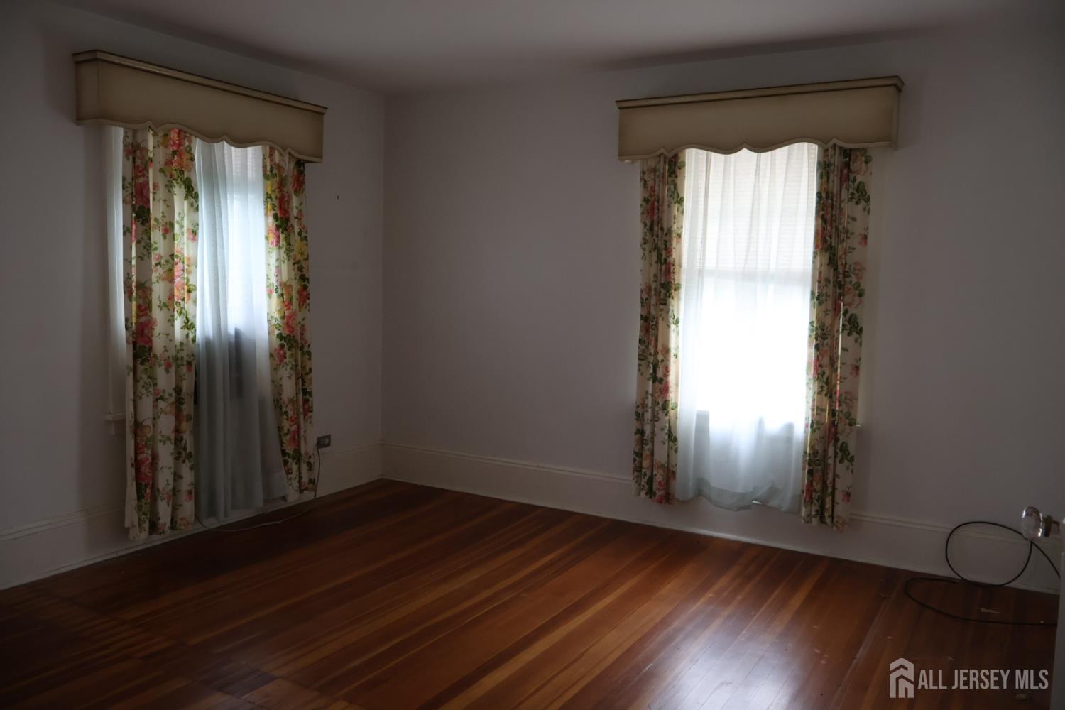 40 Prospect Street Summit, NJ 07901 - Photo 10 of 17 an empty room with wooden floor and windows