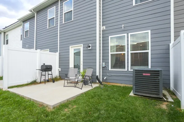 a backyard of a house with outdoor seating