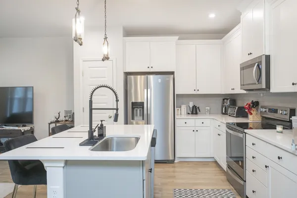 a kitchen with a sink a stove and cabinets