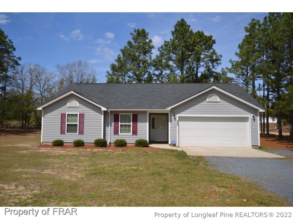 804 Loop Road Raeford, NC 28376 - Photo 1 of 26 a front view of a house with a yard and trees