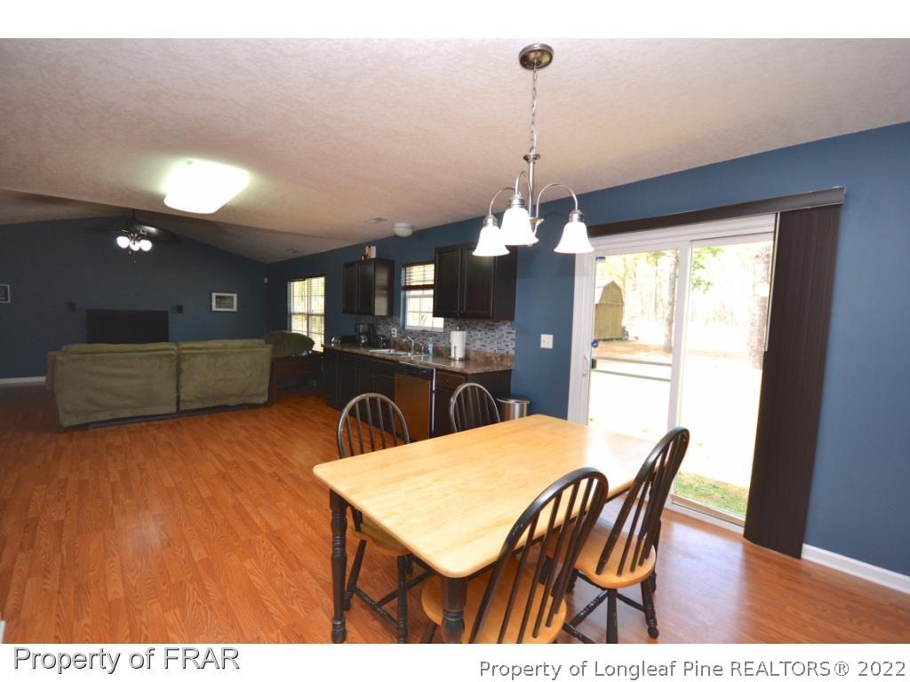 804 Loop Road Raeford, NC 28376 - Photo 11 of 26 a view of a dining room with furniture window and wooden floor
