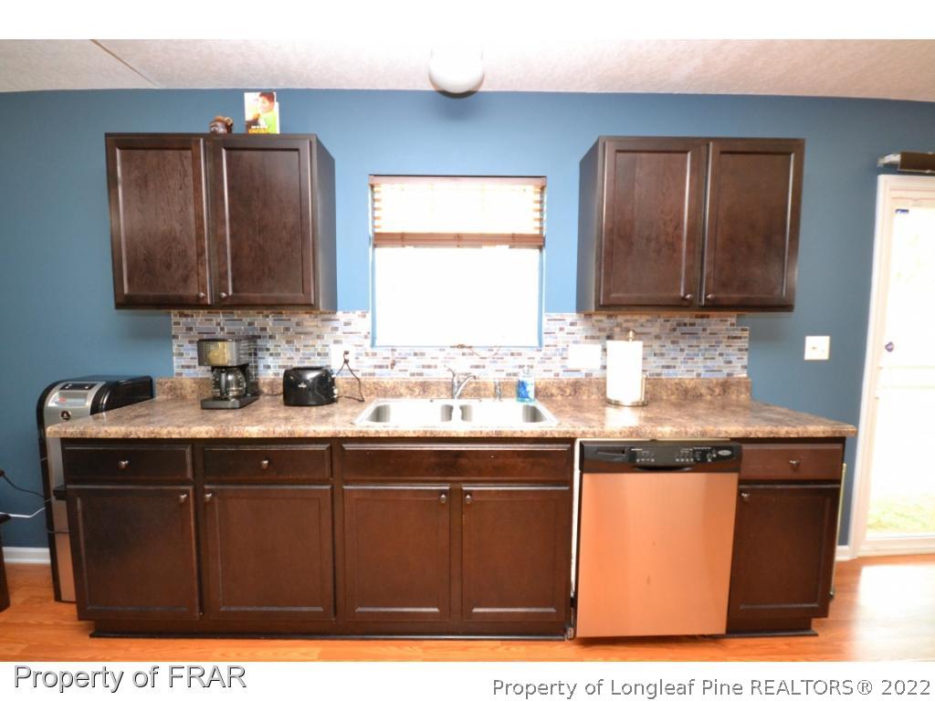 804 Loop Road Raeford, NC 28376 - Photo 8 of 26 a kitchen with granite countertop a sink cabinets and window