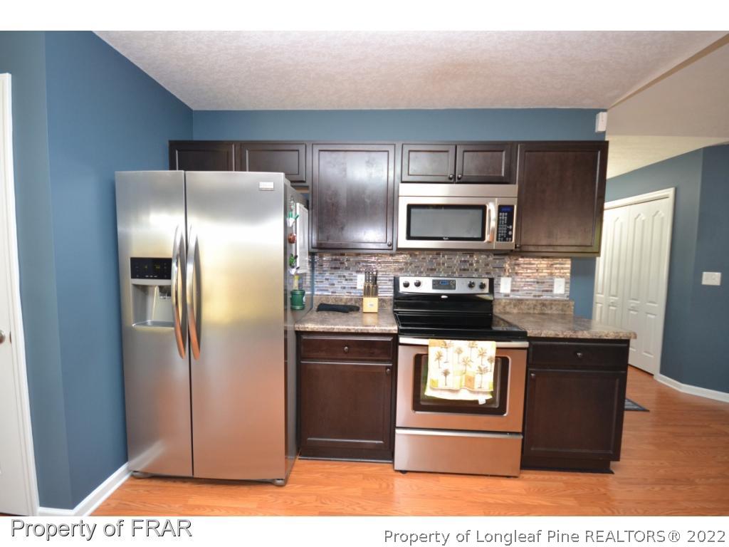 804 Loop Road Raeford, NC 28376 - Photo 9 of 26 a kitchen with stainless steel appliances granite countertop a refrigerator a stove and a sink