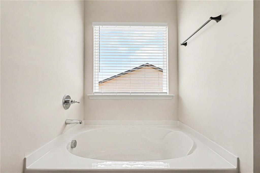 223 Malbone Street Southwest Cartersville, GA 30120 - Photo 27 of 34 a white bath tub sitting in a bathroom