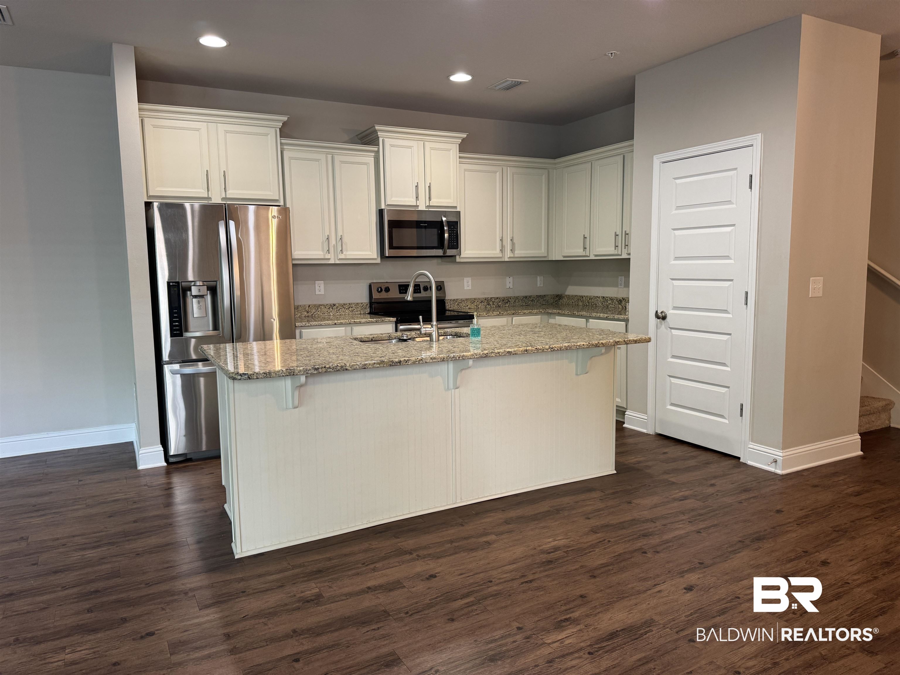 6811 Spaniel Drive, Unit C Daphne, AL 36527 - Photo 10 of 33 Kitchen with stainless steel appliances, recessed lighting, baseboards, light stone counters, and white cabinets